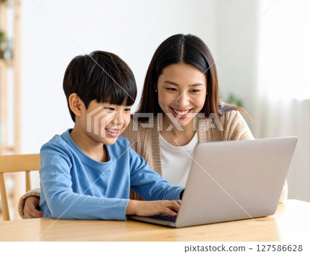 Parent and child learning to use a computer in the living room Parent and child learning to use a computer in the living room 127586628
