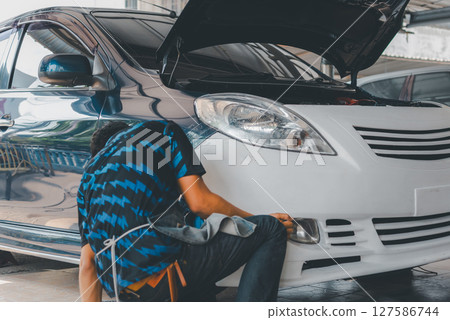 Checking car body work fiber bumper at car garage 127586744