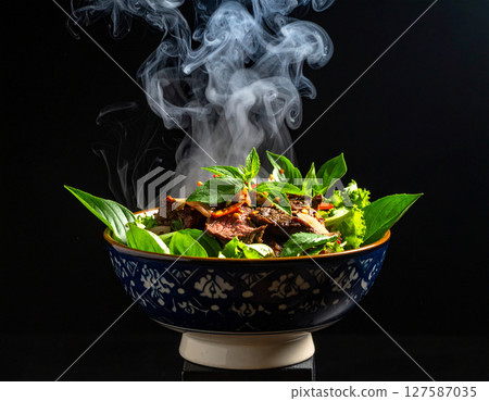 AI generated smoky thai sue rong hai grilled beef with fresh ingredients falling into ornate thai bowl juicy marinated steak spicy dipping sauce aromatic herbs 127587035