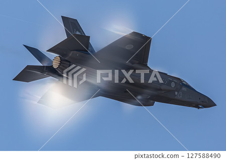 fighter jet flying in the blue sky 127588490