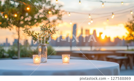 Elegant table setting with a vase of flowers and candles for a cozy ambiance 127588869
