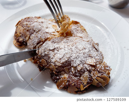 Croissant Amandine: Freshly baked almond cream croissant Croissant Amandine: Freshly baked almond cream croissant 127589109