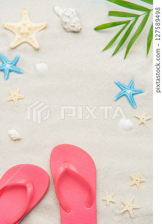 Pink flip flops, seashells, and starfishes creating relaxing summer beach background 127589498