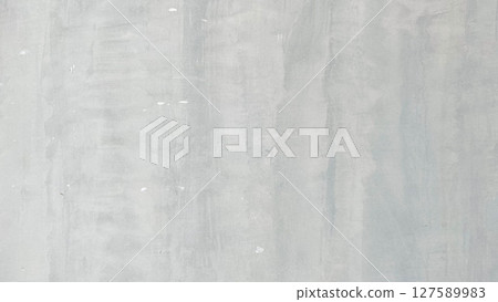 Light grey cement wall with vertical brush patterns and natural texture. Perfect for use as a neutral minimalist background or industrial interior design element. 127589983