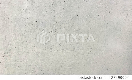Close-up of an exposed concrete wall surface with fine air holes and raw construction marks 127590004