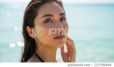 Summer portrait of a woman with the blue sea in the background 127590494