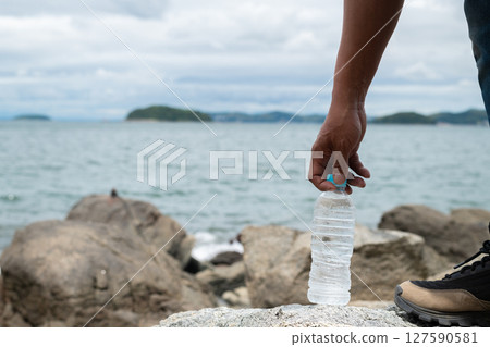 Person holding a bottle of water 127590581