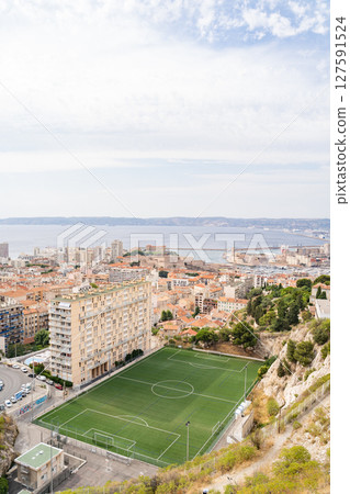 Breathtaking view of a city soccer field by the sea from an elevated position Breathtaking view of a city soccer field by the sea from an elevated position 127591524