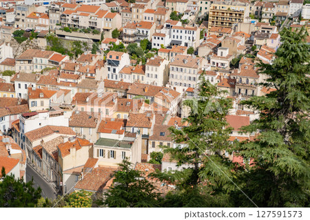 Showcase the beauty of a European town with tile roofs and greenery from above Showcase the beauty of a European town with tile roofs and greenery from above 127591573