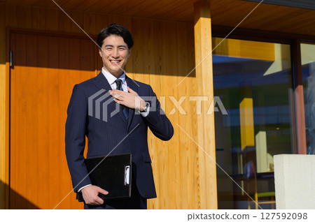 A Japanese man showing around a property A Japanese man showing around a property 127592098