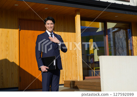 A Japanese man showing around a property A Japanese man showing around a property 127592099