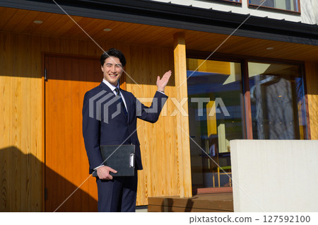 A Japanese man showing around a property A Japanese man showing around a property 127592100