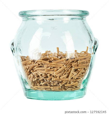 Glass jar filled raw pasta isolated on white background. File contains clipping path. 127592145