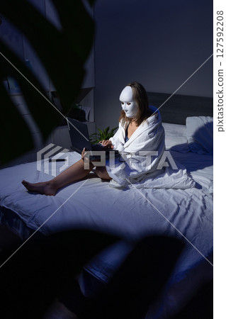 Digital Privacy Protection in a Nighttime Setting With a Masked Individual on a Laptop Digital Privacy Protection in a Nighttime Setting With a Masked Individual on a Laptop 127592208