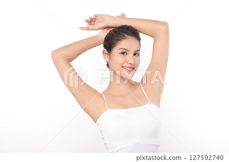 Beautiful Young Asian woman Raises her hands to Showcase clean and hygienic underarms Against a white background, Smooth armpit cleanliness and protection concept Beautiful Young Asian woman Raises her hands to Showcase clean and hygienic underarms Against a white background, Smooth armpit cleanliness and protection concept 127592740