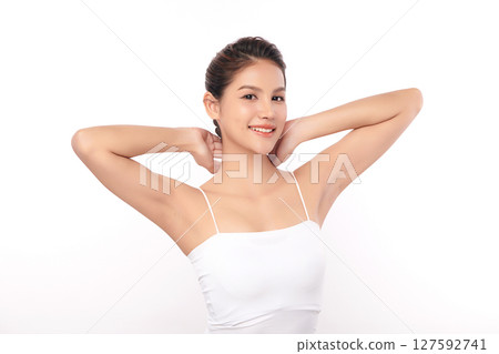Beautiful Young Asian woman Raises her hands to Showcase clean and hygienic underarms Against a white background, Smooth armpit cleanliness and protection concept 127592741
