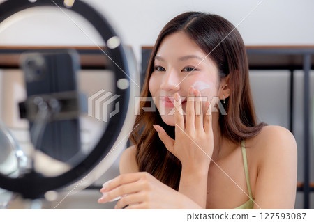 Woman presenting and review cosmetic product with excitement on social media platform for followers. 127593087