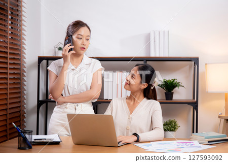 Two young asian businesswoman planning and strategy about marketing and financial. Two young asian businesswoman planning and strategy about marketing and financial. 127593092