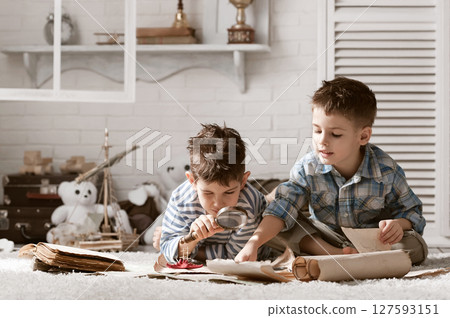 Two boys studying old maps Travel Two boys studying old maps Travel 127593151