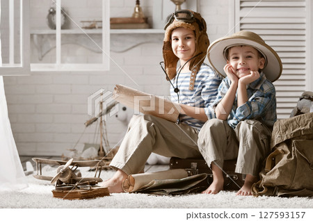 Boys in images traveler and pilot play in his room Boys in images traveler and pilot play in his room 127593157