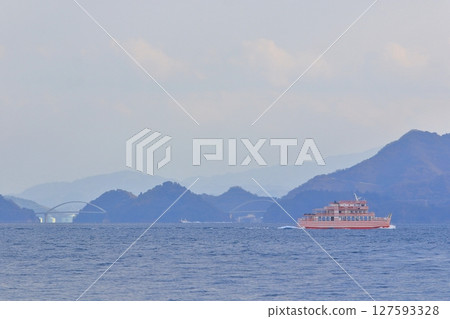 View from Oshiba Island of the Meon train sailing through the Seto Inland Sea View from Oshiba Island of the Meon train sailing through the Seto Inland Sea 127593328