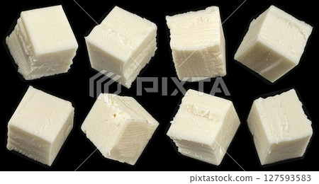 Falling cubes of white cheese isolated on black background, copy space 127593583