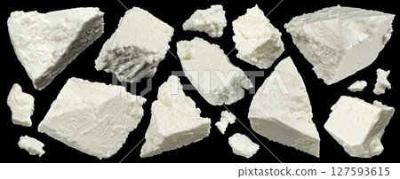 Falling sliced feta, flying white cheese pieces on black background Falling sliced feta, flying white cheese pieces on black background 127593615