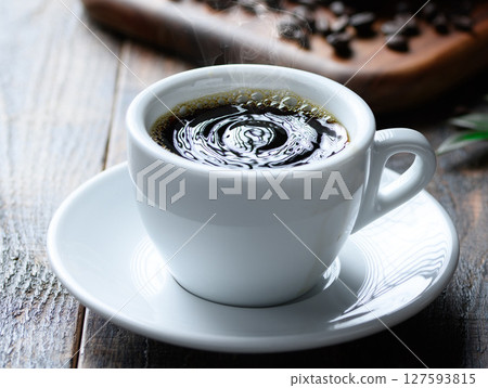 Hot coffee and coffee beans (dark background) Hot coffee and coffee beans (dark background) 127593815