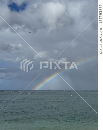A rainbow over the ocean 127593885