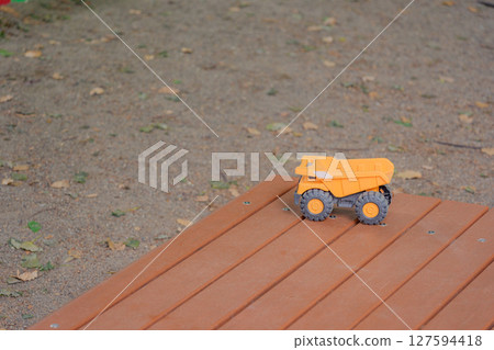 Dump truck toy forgotten on a park bench 127594418