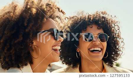 Joyful moments captured with female friends, their laughter brightens the day under a clear sky 127595133