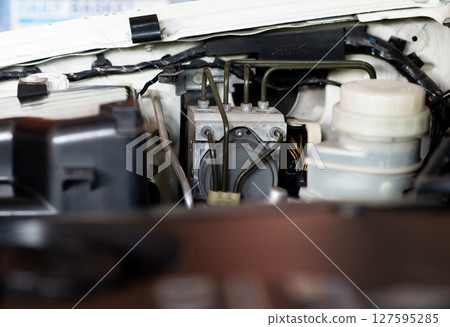 ABS brake system in car engine compartment ABS brake system in car engine compartment 127595285