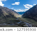 Scenic view of Chulyshman River Valley in Altai. lush green vegetation and towering mountains under cloudy sky. Travel and landscape photography. 127595930