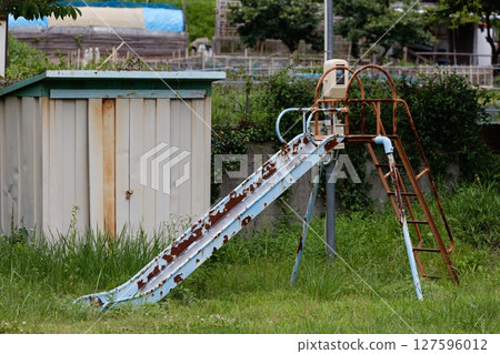Unused playground equipment: slide 127596012