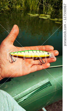 Fishing Lure in Hand Outdoors Fishing Lure in Hand Outdoors 127598967