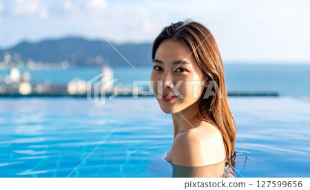 Woman by the pool Woman by the pool 127599656