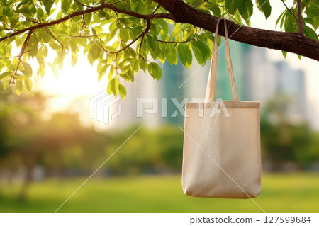 Eco-Friendly Tote Bag Hanging from Tree Branch with Natural Background in Soft Light 127599684