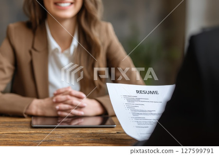 Confident Candidate Presenting Digital Portfolio During Interview at Modern Office Setting 127599791