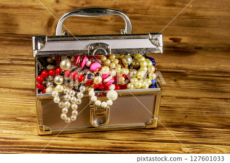Jewelry box full of jewelry and accessories on wooden background 127601033