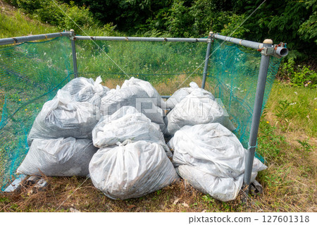 Photo of garbage bags at a garbage dump 127601318