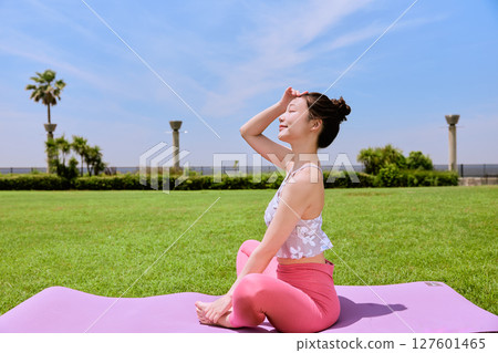 Enjoy yoga and pilates in a resort atmosphere under natural grass and blue skies. 127601465