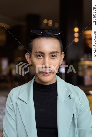 Portrait of nonbinary genderfluid young Asian gay man in cafe Portrait of nonbinary genderfluid young Asian gay man in cafe 127601799