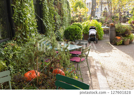 Empty table in autumn garden decorated for Halloween Empty table in autumn garden decorated for Halloween 127601828