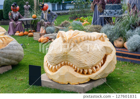 Park decoration and scary face carved into a pumpkin for Halloween Park decoration and scary face carved into a pumpkin for Halloween 127601831