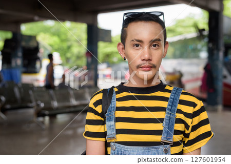 Portrait of nonbinary genderfluid young Asian gay tourist man in bus terminal 127601954