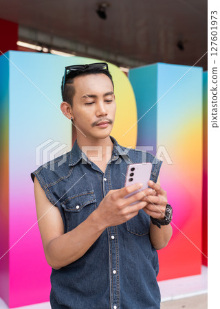 Portrait of confident non binary gay man during pride outdoors Portrait of confident non binary gay man during pride outdoors 127601973