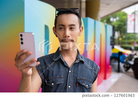 Portrait of confident non binary gay man during pride outdoors Portrait of confident non binary gay man during pride outdoors 127601983