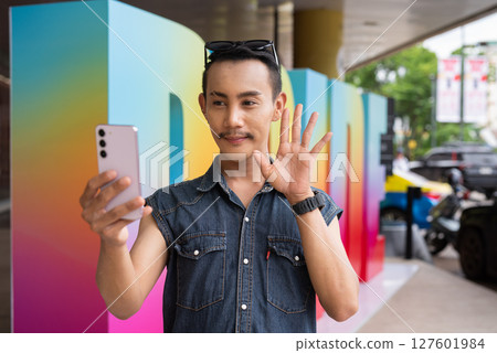 Portrait of confident non binary gay man during pride outdoors 127601984