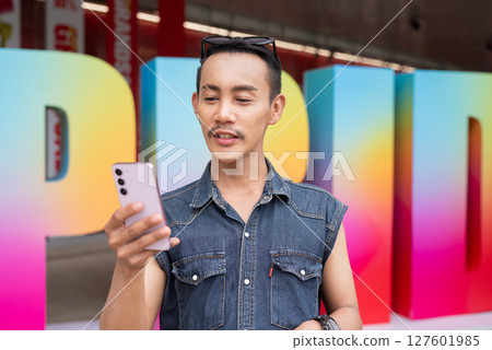 Portrait of confident non binary gay man during pride outdoors 127601985