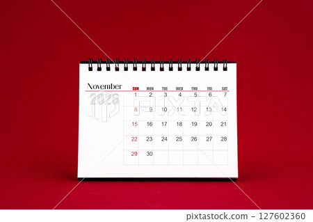 November 2026 Blank desk calendar on red color background. 127602360